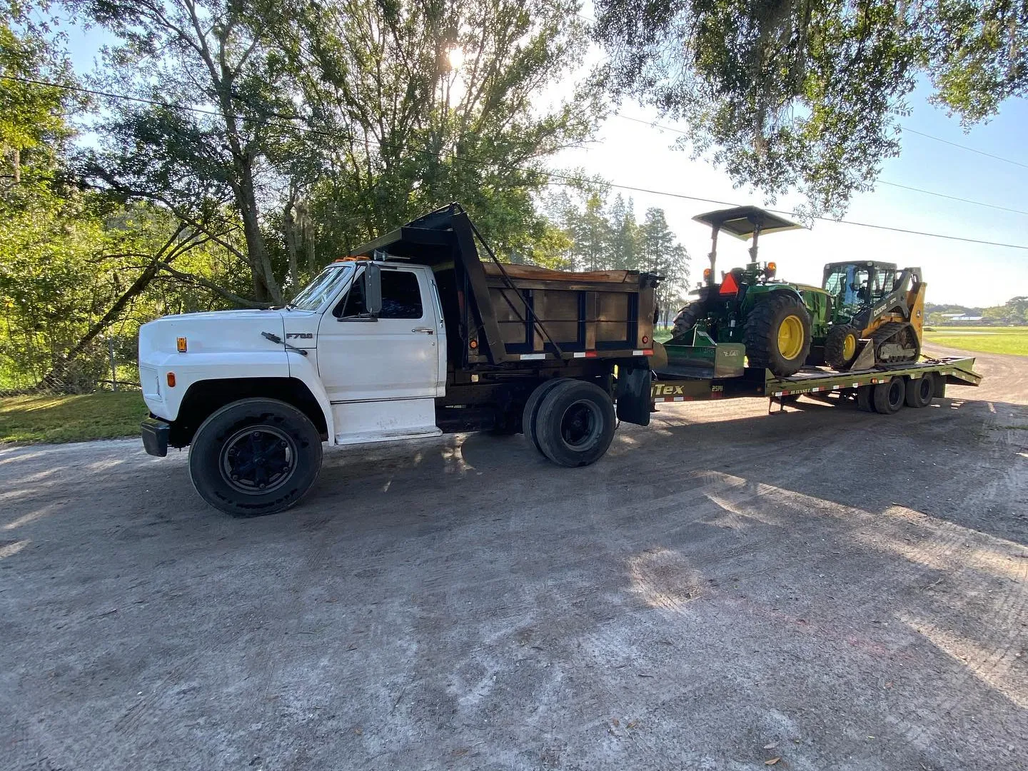 Dump truck and a tractor on a trailer at a job site, the rig that hauls debris off